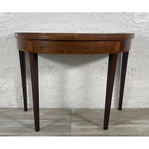 184 - A George III inlaid mahogany demi lune fold over card table - approx. 73cm high x 99cm wide x 46cm d... 