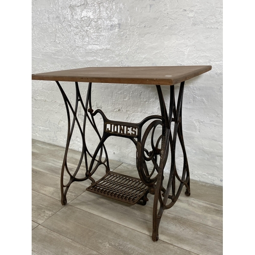 64 - A late 19th/early 20th century Jones cast iron treadle sewing machine base converted table - approx.... 