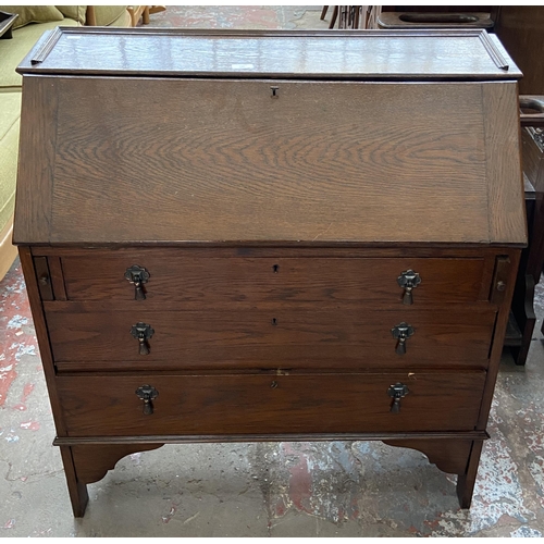 199 - A 1930s oak bureau - approx. 96cm high x 90cm wide x 42cm deep