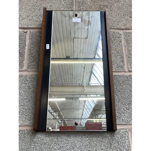 7 - A mid 20th century teak and ebonised framed wall mirror - approx. 56cm high x 31cm wide