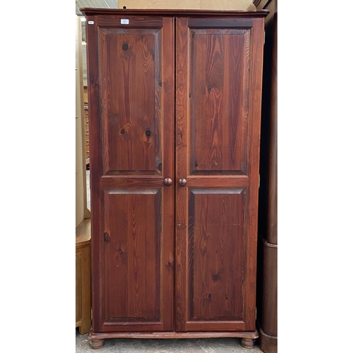 205 - A modern stained pine double wardrobe - approx. 180cm high x 95cm wide x 50cm deep