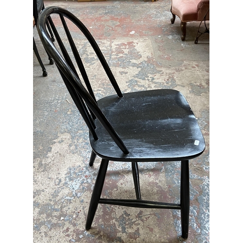 71 - Three pieces of furniture, two Ercol style black painted dining chairs and one beech effect bedside ... 