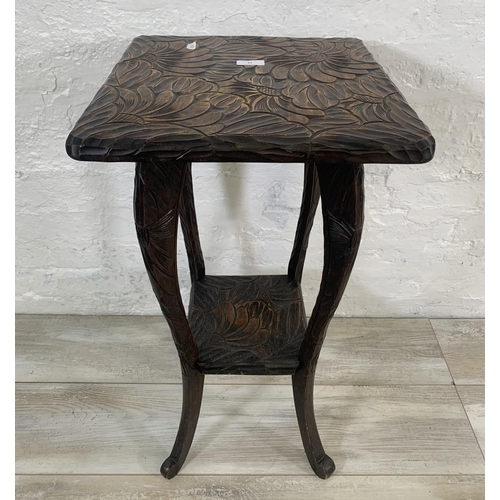 21 - An Arts & Crafts Liberty & Co. Japanese hand carved wooden two tier side table - approx. 70cm high x... 