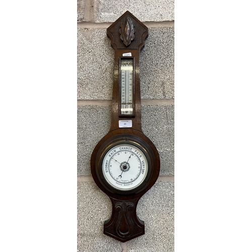 23 - A late 19th century carved oak aneroid barometer - approx. 66cm high