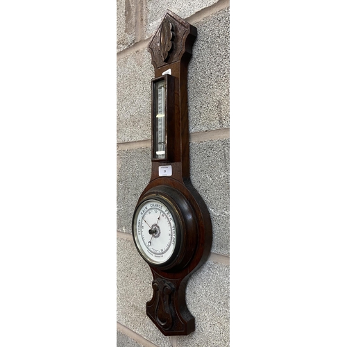 23 - A late 19th century carved oak aneroid barometer - approx. 66cm high