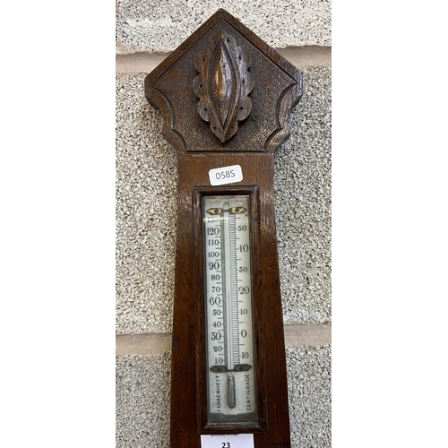 23 - A late 19th century carved oak aneroid barometer - approx. 66cm high