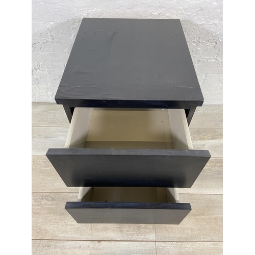 75 - An IKEA black laminate bedside chest of drawers - approx. 55cm high x 40cm wide x 49cm deep