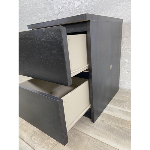 75 - An IKEA black laminate bedside chest of drawers - approx. 55cm high x 40cm wide x 49cm deep