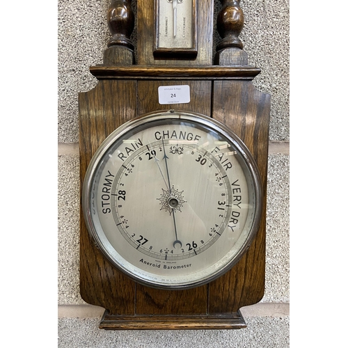 24 - An early/mid 20th century carved oak aneroid barometer - approx. 70cm high