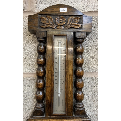 24 - An early/mid 20th century carved oak aneroid barometer - approx. 70cm high