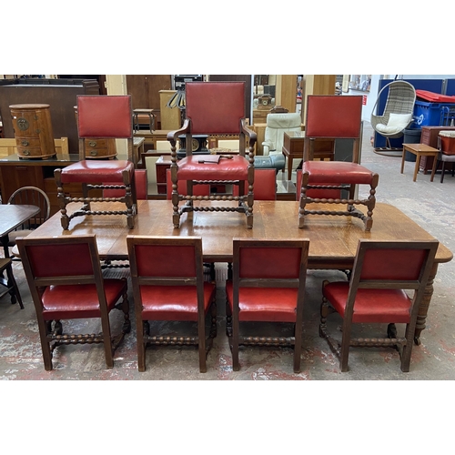 78 - A Victorian oak wind out extending dining table and eleven Cromwellian style oak and red vinyl chair... 