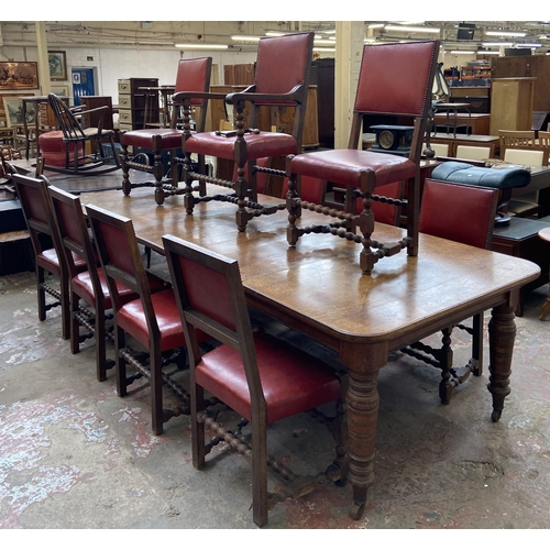 78 - A Victorian oak wind out extending dining table and eleven Cromwellian style oak and red vinyl chair... 