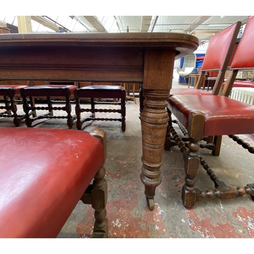 78 - A Victorian oak wind out extending dining table and eleven Cromwellian style oak and red vinyl chair... 