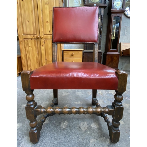 78 - A Victorian oak wind out extending dining table and eleven Cromwellian style oak and red vinyl chair... 