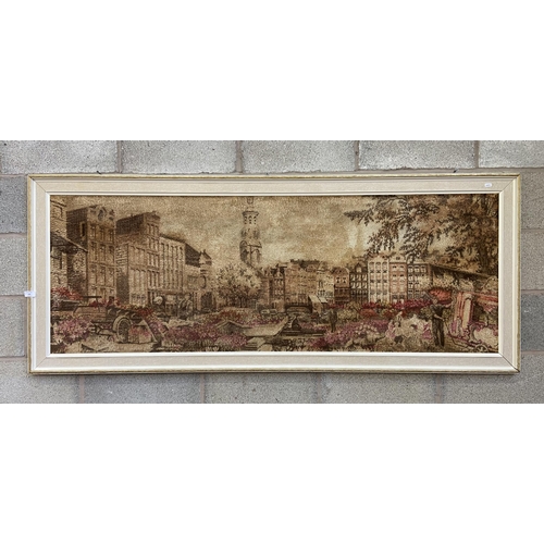 250 - A mid 20th century framed dyed fabric picture of a European scene - approx. 74cm high x 180cm wide