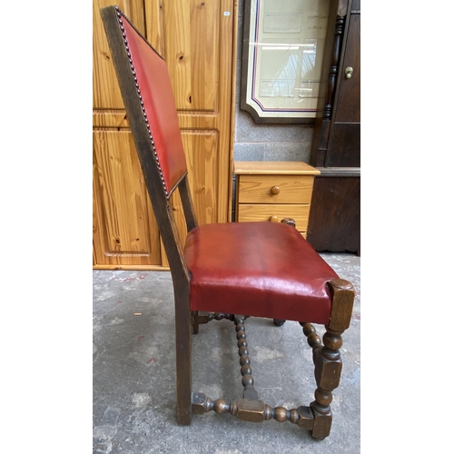 78 - A Victorian oak wind out extending dining table and eleven Cromwellian style oak and red vinyl chair... 