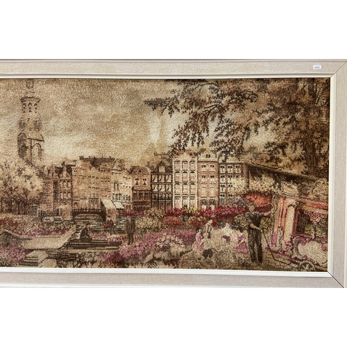 250 - A mid 20th century framed dyed fabric picture of a European scene - approx. 74cm high x 180cm wide