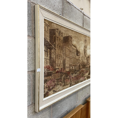 250 - A mid 20th century framed dyed fabric picture of a European scene - approx. 74cm high x 180cm wide