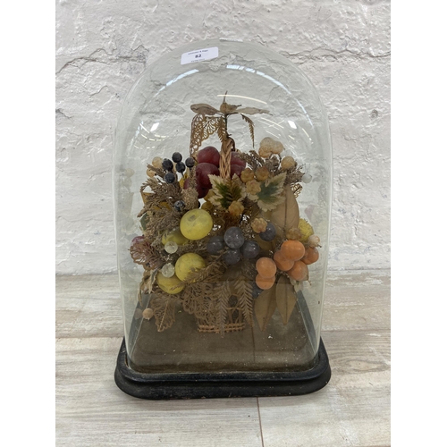 82 - A Victorian wax fruit display under glass dome on ebonised stand - approx. 43cm high x 29cm wide x 2... 