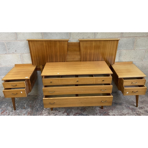 27 - An Alfred Cox walnut two piece bedroom suite comprising chest of drawers and headboard with fitted t... 