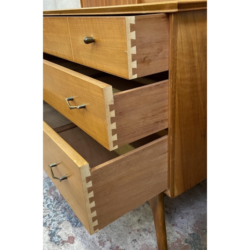 27 - An Alfred Cox walnut two piece bedroom suite comprising chest of drawers and headboard with fitted t... 