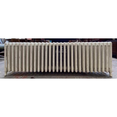 84 - A white painted cast iron radiator - approx. 47cm high x 150cm wide x 22cm deep