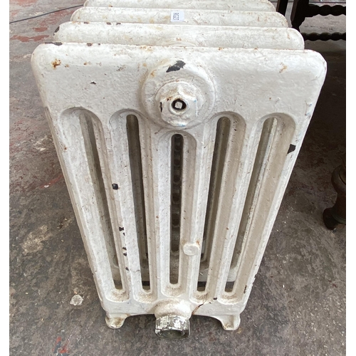 84 - A white painted cast iron radiator - approx. 47cm high x 150cm wide x 22cm deep