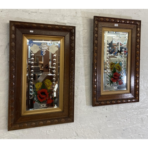 29 - A pair of Edwardian carved oak framed bevelled edge gypsy wall mirrors with butterfly and floral des... 