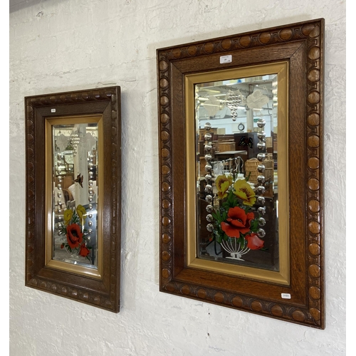 29 - A pair of Edwardian carved oak framed bevelled edge gypsy wall mirrors with butterfly and floral des... 