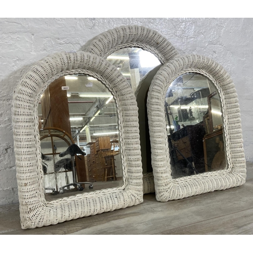 31 - Three white painted wicker framed wall mirrors - largest approx. 73cm high x 50cm wide