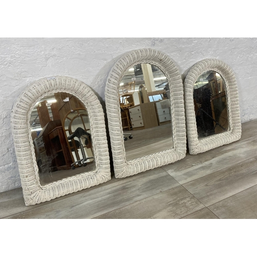 31 - Three white painted wicker framed wall mirrors - largest approx. 73cm high x 50cm wide