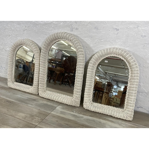 31 - Three white painted wicker framed wall mirrors - largest approx. 73cm high x 50cm wide