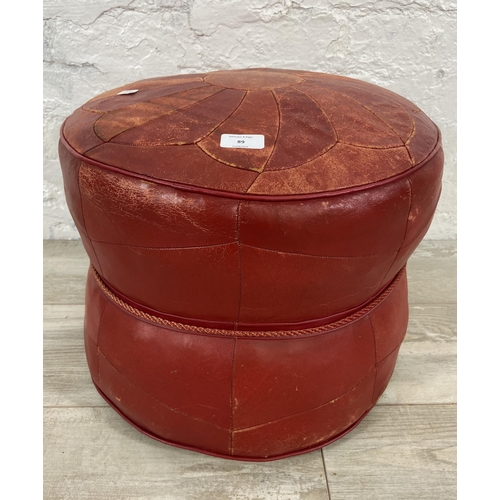 89 - A mid 20th century Moroccan red leather circular footstool - approx. 38cm high x 44cm diameter