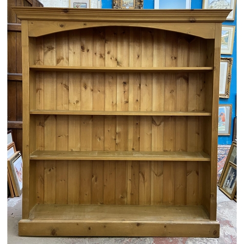 33 - A Victorian style pine four tier bookcase - approx. 147cm high x 137cm wide x 28cm deep