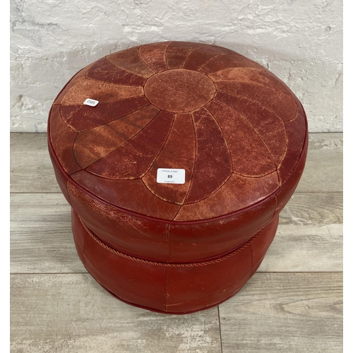 89 - A mid 20th century Moroccan red leather circular footstool - approx. 38cm high x 44cm diameter