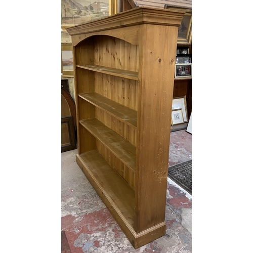 33 - A Victorian style pine four tier bookcase - approx. 147cm high x 137cm wide x 28cm deep