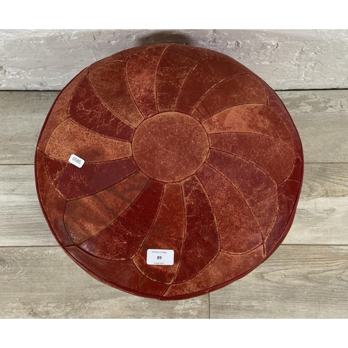 89 - A mid 20th century Moroccan red leather circular footstool - approx. 38cm high x 44cm diameter