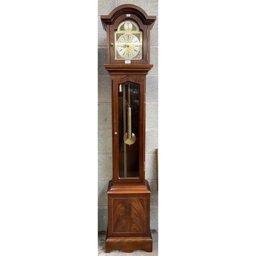 9 - A Thomas Byrne mahogany cased grandmother clock with brass face, pendulum and weights - approx. 180c... 