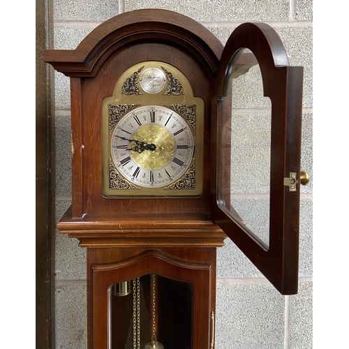 9 - A Thomas Byrne mahogany cased grandmother clock with brass face, pendulum and weights - approx. 180c... 