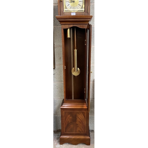 9 - A Thomas Byrne mahogany cased grandmother clock with brass face, pendulum and weights - approx. 180c... 