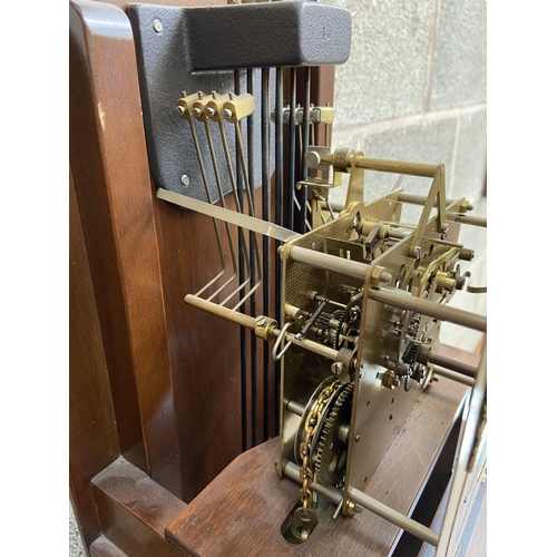 9 - A Thomas Byrne mahogany cased grandmother clock with brass face, pendulum and weights - approx. 180c... 