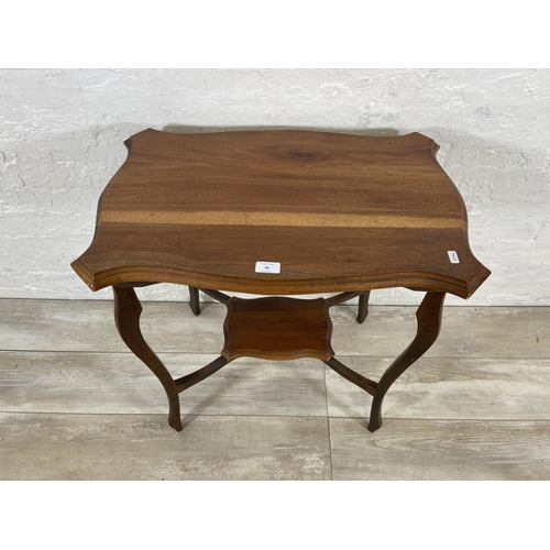 90 - An Edwardian walnut serpentine two tier side table - approx. 73cm high x 66cm wide x 43cm deep