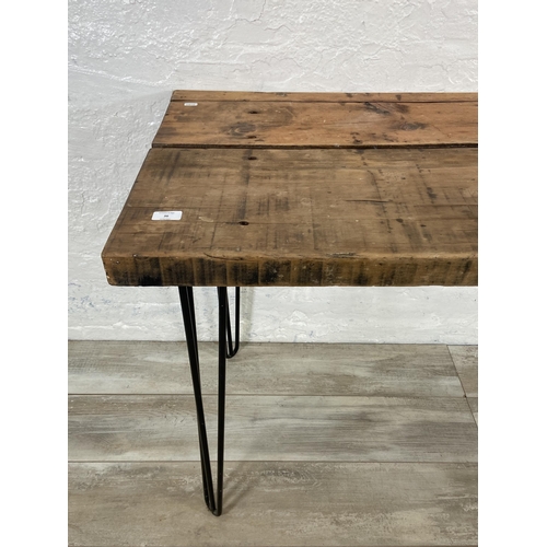 36 - An Industrial style pine desk on black tubular metal hairpin supports - approx. 76cm high x 156cm wi... 