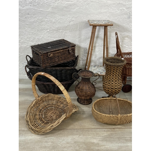 91 - A collection of wicker baskets and vases together with a bamboo plant stand with ceramic tile insert... 