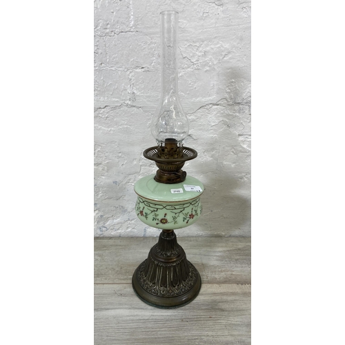 37 - Three Victorian cast metal and glass oil lamps, two Young's and one British Made - largest approx. 6... 