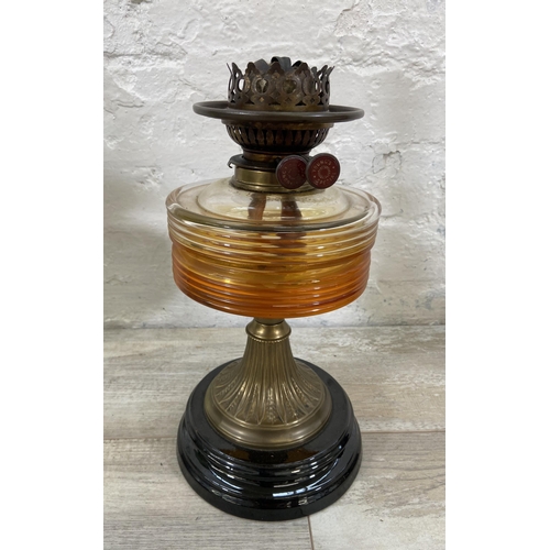 37 - Three Victorian cast metal and glass oil lamps, two Young's and one British Made - largest approx. 6... 