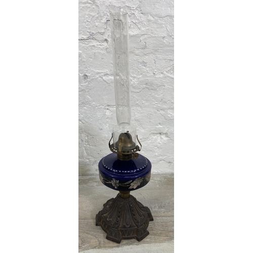 37 - Three Victorian cast metal and glass oil lamps, two Young's and one British Made - largest approx. 6... 