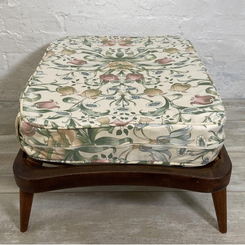 39 - An Ercol beech footstool with floral upholstered cushion - approx. 35cm high x 69cm wide x 52cm deep