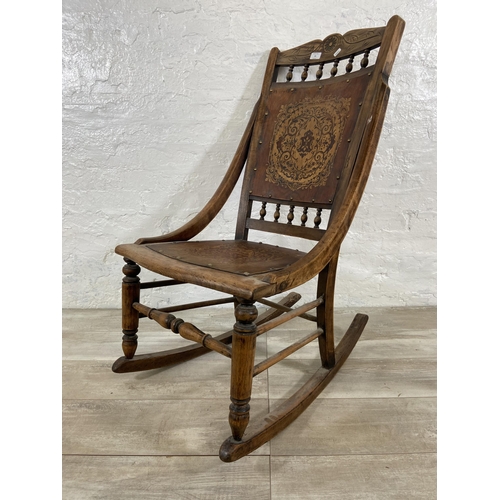 99 - An early 20th century beech rocking chair with embossed design