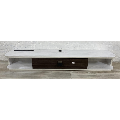 43 - A modern white laminate and wood effect wall mountable media unit - approx. 16cm high x 120cm wide x... 